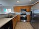 Kitchen with stainless steel appliances and wood cabinets at 938 Cantabria Heights Ave, Las Vegas, NV 89183