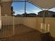 Small fenced patio with gravel and shade canopy at 938 Cantabria Heights Ave, Las Vegas, NV 89183