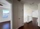 Upstairs hallway with dark hardwood floors and two bedrooms at 938 Cantabria Heights Ave, Las Vegas, NV 89183