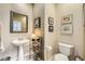 Elegant powder room featuring a pedestal sink and decorative accents at 939 Paisley St, Las Vegas, NV 89145