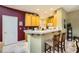 Kitchen with light wood cabinets, breakfast bar, and view of dining area at 939 Paisley St, Las Vegas, NV 89145