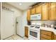 Bright kitchen with oak cabinets, white appliances, and tiled floors at 939 Paisley St, Las Vegas, NV 89145