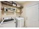 Laundry room with washer, dryer, and shelving at 939 Paisley St, Las Vegas, NV 89145