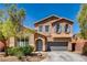 Two-story house with gray doors and blue shutters at 10161 Kermode Ct, Las Vegas, NV 89178