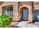 Inviting front entrance with a blue door and arched entryway at 10161 Kermode Ct, Las Vegas, NV 89178