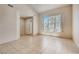 Bright and spacious living room with tile flooring and large window at 10161 Kermode Ct, Las Vegas, NV 89178