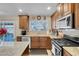 Bright kitchen with stainless steel appliances, granite counters and wood cabinets at 1020 Blue Lantern Dr, Henderson, NV 89015