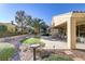 Landscaped backyard with artificial turf and a bird bath at 10247 Santo Nina Ct, Las Vegas, NV 89135