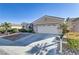 Single story home with a two-car garage and nicely landscaped yard at 10247 Santo Nina Ct, Las Vegas, NV 89135