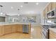 Modern kitchen with island, stainless steel appliances, and hardwood floors at 10247 Santo Nina Ct, Las Vegas, NV 89135