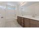 Bathroom with double vanity, bathtub, and tile flooring at 10409 Mont Pourri Ct, Las Vegas, NV 89149