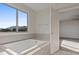 Bathroom with soaking tub and mountain views at 10409 Mont Pourri Ct, Las Vegas, NV 89149