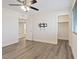 Spacious bedroom with ceiling fan, closet, and wood-look flooring at 10409 Mont Pourri Ct, Las Vegas, NV 89149