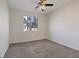 Well-lit bedroom with ceiling fan and carpeted floor at 10409 Mont Pourri Ct, Las Vegas, NV 89149