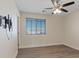 Bedroom with ceiling fan, window, and wood-look flooring at 10409 Mont Pourri Ct, Las Vegas, NV 89149