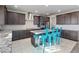 Modern kitchen with granite countertops and blue stools at 10409 Mont Pourri Ct, Las Vegas, NV 89149