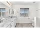 Bright bathroom with double vanity, modern fixtures, and a window for natural light at 10452 Prairie Schooner Ave, Las Vegas, NV 89129