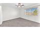 Bedroom with neutral carpet, a ceiling fan, and a window with outside views at 10452 Prairie Schooner Ave, Las Vegas, NV 89129