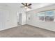 Bedroom with new carpet, a view of the neighborhood, and closet access at 10452 Prairie Schooner Ave, Las Vegas, NV 89129