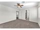 Spacious bedroom with new carpet and multiple doorways, including one to the ensuite bathroom at 10452 Prairie Schooner Ave, Las Vegas, NV 89129