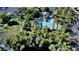 Aerial view of a community pool area landscaped with palms and lush greenery at 10452 Prairie Schooner Ave, Las Vegas, NV 89129