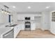 Modern kitchen featuring stainless steel appliances, white cabinetry, and an island with a marble countertop at 10452 Prairie Schooner Ave, Las Vegas, NV 89129