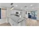 Well-lit kitchen with stainless steel appliances, light stone countertops, and breakfast bar at 10452 Prairie Schooner Ave, Las Vegas, NV 89129