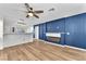 Open living area with hardwood floors, blue accent wall with modern fireplace at 10452 Prairie Schooner Ave, Las Vegas, NV 89129