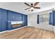 Cozy living room featuring wood floors, a fireplace, and a modern ceiling fan at 10452 Prairie Schooner Ave, Las Vegas, NV 89129