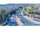 View of a gated street entrance with palm trees and sidewalks in the foreground at 10452 Prairie Schooner Ave, Las Vegas, NV 89129