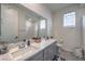 Modern bathroom with double vanity, quartz countertop and bathtub at 10640 Skye Scout Ave, Las Vegas, NV 89166