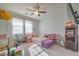 Bright bedroom featuring a twin-size bed and arcade game at 10640 Skye Scout Ave, Las Vegas, NV 89166