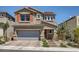 Two-story house with gray garage door, orange accents, and landscaped yard at 10640 Skye Scout Ave, Las Vegas, NV 89166