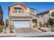 Two-story house with gray garage door, orange accents, and landscaped yard at 10640 Skye Scout Ave, Las Vegas, NV 89166