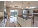 Modern kitchen with white cabinets, large island, and stainless steel appliances at 10640 Skye Scout Ave, Las Vegas, NV 89166