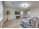 Open living area with gray sectional sofa and wood-look floors at 10640 Skye Scout Ave, Las Vegas, NV 89166