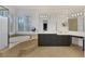 Bathroom with double vanity, large soaking tub, and separate shower at 10779 Crown Ct, Las Vegas, NV 89141