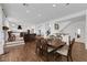 Elegant dining room features a dark wood table with matching chairs, hardwood floors, and views into the kitchen at 10779 Crown Ct, Las Vegas, NV 89141