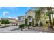 Two-story house with a three-car garage, landscaping, and a large front yard at 10779 Crown Ct, Las Vegas, NV 89141