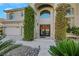 Elegant entryway with double doors and lush landscaping at 10779 Crown Ct, Las Vegas, NV 89141