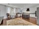 Modern kitchen with island, white cabinets, and hardwood floors at 10779 Crown Ct, Las Vegas, NV 89141