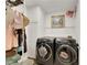 Bright laundry room with washer, dryer, and ample storage at 10779 Crown Ct, Las Vegas, NV 89141