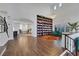 Open living area with hardwood floors, built-in bookcase, and a grand piano at 10779 Crown Ct, Las Vegas, NV 89141