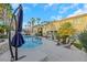 Relaxing pool area with palm trees and a large patio at 10779 Crown Ct, Las Vegas, NV 89141