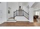 View of a grand staircase with a wrought iron railing and hardwood floors at 10779 Crown Ct, Las Vegas, NV 89141