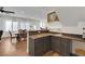 Dark wood wet bar with granite countertop and under-cabinet lighting at 10779 Crown Ct, Las Vegas, NV 89141