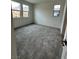 Bright bedroom with neutral carpet and multiple windows, offering ample natural light at 1521 Bat Hawk St, Las Vegas, NV 89138