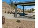 Community common area with a covered structure, landscaping, and a gravel ground cover at 1521 Bat Hawk St, Las Vegas, NV 89138