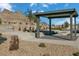 View of a community amenity space including an open air lounge, landscape design, and surrounding desert views at 1521 Bat Hawk St, Las Vegas, NV 89138