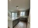 Open kitchen with grey cabinets, a central island, and a sliding glass door at 1521 Bat Hawk St, Las Vegas, NV 89138